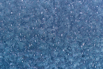 Frost patterns on window glass in winter, close up