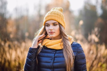 autumn girl in yellow hat and scarf