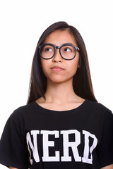 Close up of young Asian teenage nerd girl thinking