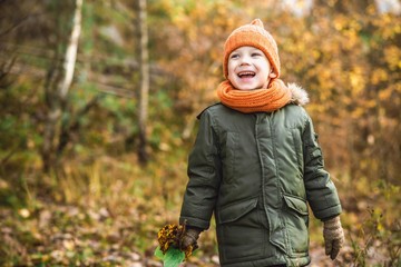 boy in orange hat and scarf walking