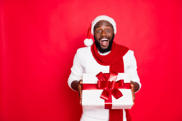 Wow its for me. Portrait of excited african man in santa claus cap hold big package get present for...