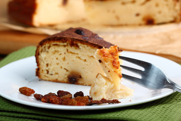 Slice of Cheesecake with raisins on plate