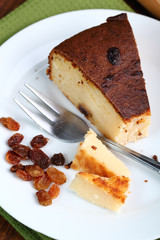 Slice of Cheesecake with raisins on plate