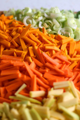 Chopped leek, pumpkin, carrot and zucchini on a cutting board. Selective focus, close-up.