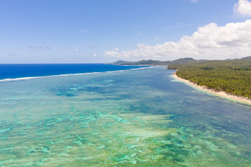 Plakat Seascape, coast of the island of Siargao, Philippines. Blue sea with waves and sky with big clouds, top view.