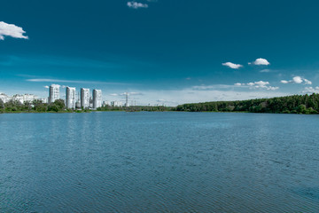 Wide lake with city and forest on the far shore
