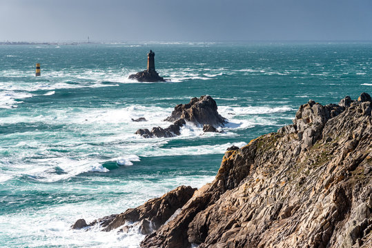 The Pointe du Raz, Brittany. This rocky cape faces the island of Sein. The giant waves of the Atlantic Ocean are shattered on the rocks and at the foot of La Vieille lighthouse.