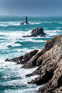 The Pointe du Raz, Brittany. This rocky cape faces the island of Sein. The giant waves of the Atlantic Ocean are shattered on the rocks and at the foot of La Vieille lighthouse.