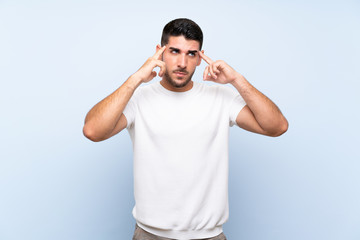 Caucasian handsome man over isolated blue background having doubts and thinking