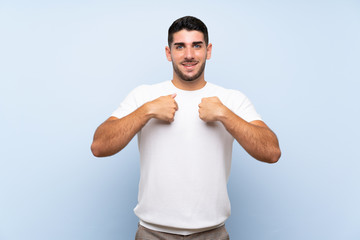 Caucasian handsome man over isolated blue background with surprise facial expression
