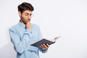 Photo of multiethnic intelligent guy making math decisions looking minded to own notice in planner wear casual denim shirt isolated white color background