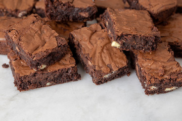Chocolate brownies cakes on a white marble base top view looking down