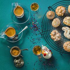 different classic Italian homemade almond cookies with espresso coffee and glasses of sweet liquor on the table, New Year's Christmas decor