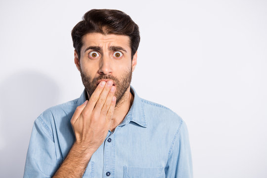 Close up photo of amazing multiethnic guy watching horror movie at cinema holding paln on opem mouth wear casual denim shirt isolated white color background