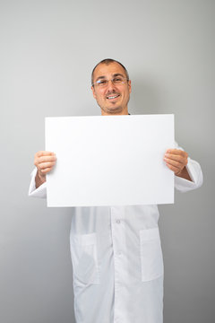 Doctor holding blank white banner