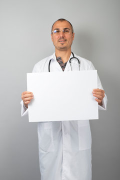 Doctor holding blank white banner