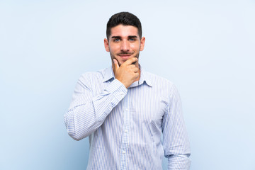 Caucasian handsome man over isolated blue background laughing