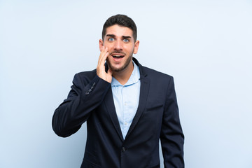 Handsome man over isolated blue background with surprise and shocked facial expression