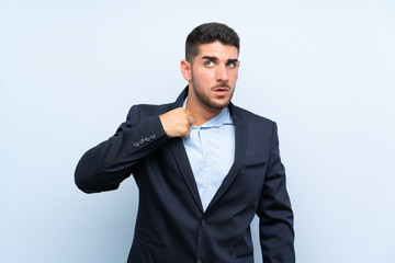 Handsome man over isolated blue background with tired and sick expression