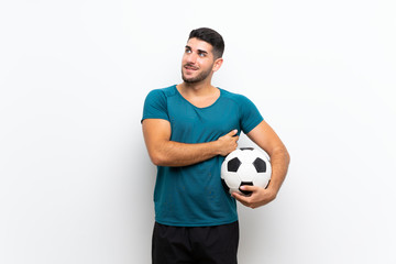 Handsome young football player man over isolated white wall looking up while smiling