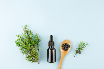 Juniper tree berry latin Juniperus communis  essential oil in brown dropper bottle, juniper tree...