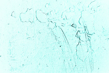 Vintage azure background. Rough painted wall of turquoise color. Imperfect plane of cyan colored. Uneven old decorative toned backdrop of aqzure tint. Texture of teal hue. Ornamental stony surface.