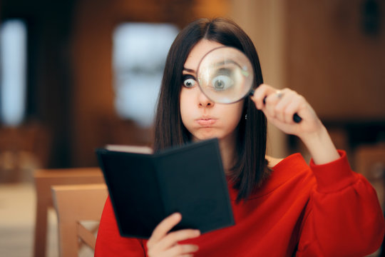 Funny Woman Checking Restaurant Bill With A Magnifying Glass