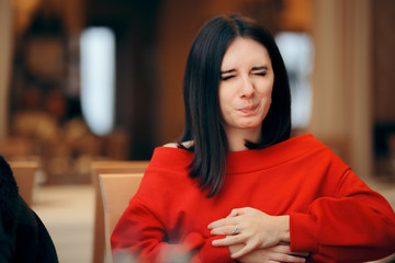Woman Suffering a Stomachache after Eating in a Restaurant