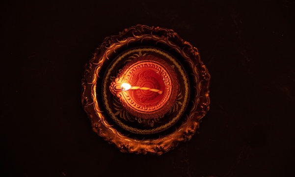 Happy Diwali. Diya Oil Lamp Top View, Black Background