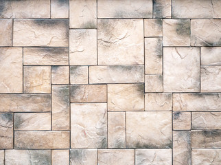 The beige-gray rectangular tiles are laid out in different directions and create an attractive vibrant backdrop