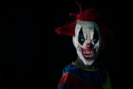 scary evil clown with a bloody mouth