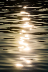 Golden sunset with sun reflection on river surface