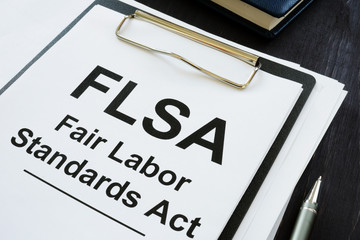 Business photo shows printed text FLSA Fair Labor Standards Act