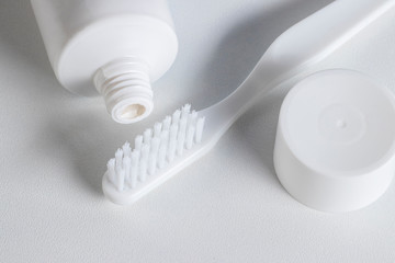 Fototapeta na wymiar White toothbrush, tube of toothpaste.
