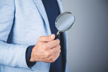 business man hand magnifier