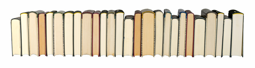 old books in a row as panorama on white background