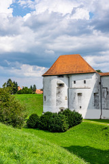 Fototapeta na wymiar Historical fortress of old castle in Varazdin city, Croatia, green trees and sunny summer day