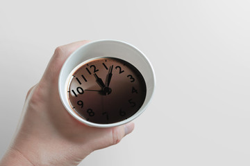 coffee time. Coffee and clock reflected on the surface. ...