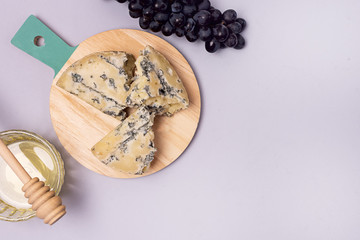 Honey Cheeses and Red Grapes on Blue Background Top View Flat Lay Copy Space