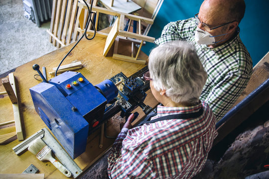 Top view of senior couple working in a carpentry workshop