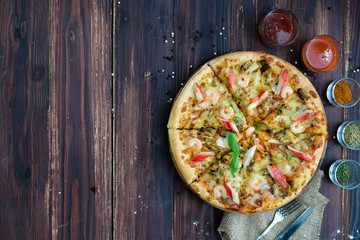 pizza on the wood table. Top view with copyspace for your text