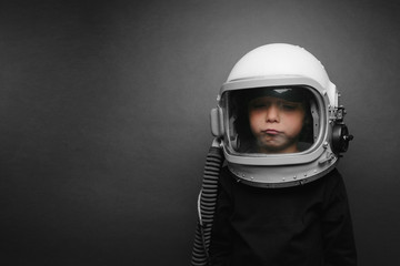 Small child wants to fly an airplane wearing an airplane helmet