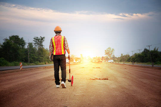 Engineer Using Distance Measure Wheel On The Road