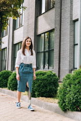full length view of smiling disabled woman walking on street