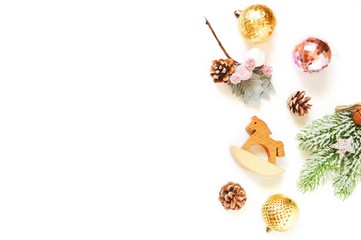 Shiny yellow balls, pine cones, spruce branch and toy wooden horse. Flat lay Christmas photo. New Year background. Mockup, free space for text