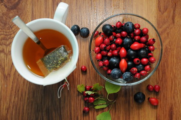 forest fruit in a glass bowl on a wooden table as decoration