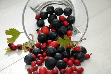 forest fruit in a glass bowl on a wooden table as decoration