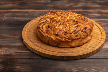 Cornish apple pie close up on rustic style wooden board