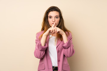 Young brunette girl with blazer over isolated background showing a sign of silence gesture