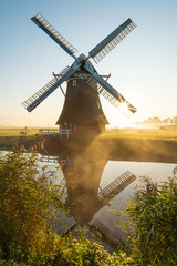 Windmill during a foggy sunrise in the Dutch countryside. Krimstermolen, Zuidwolde.
